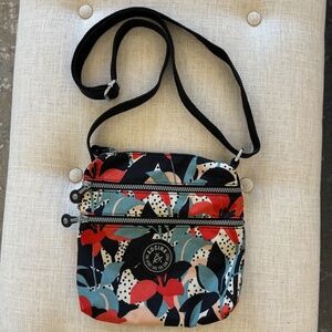 AOCINA lightweight nylon crossbody travel bag with a multi-color floral and polk